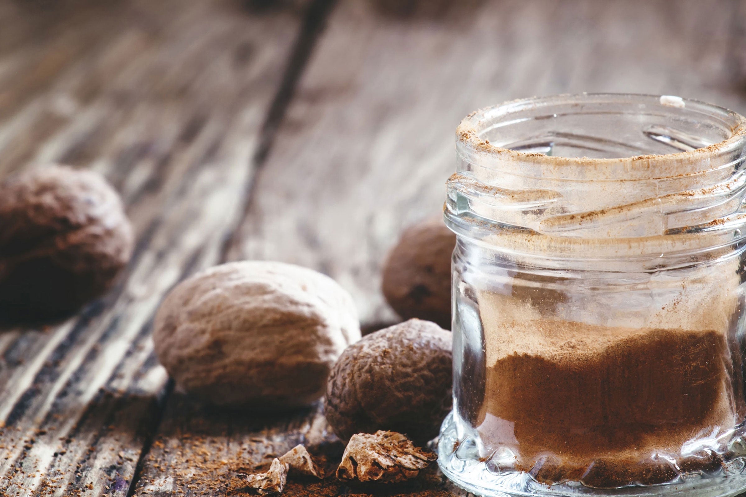 Ground nutmeg and warm spice tones representing the Cedar & Nutmeg fragrance