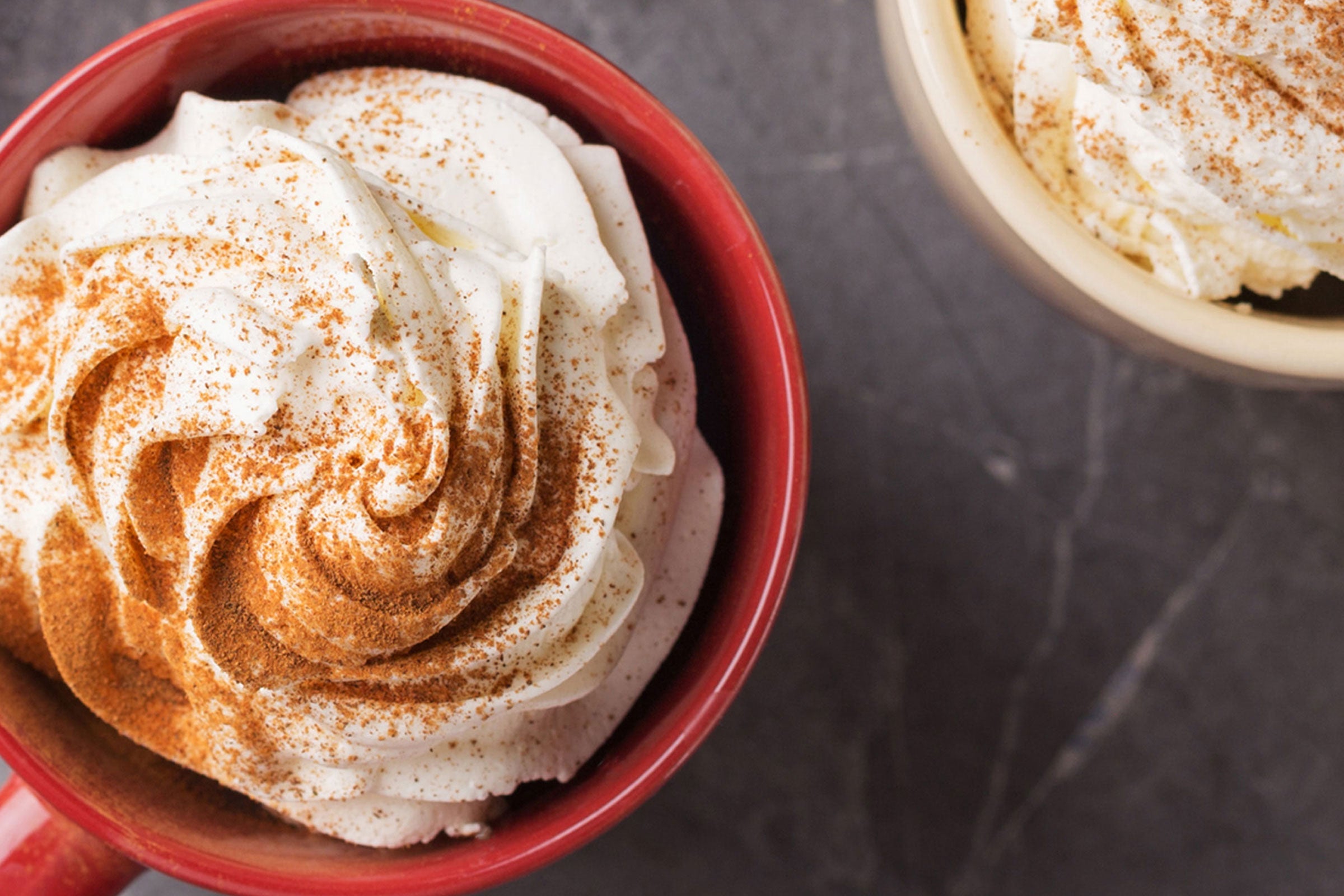 Whipped cream dusted with cinnamon representing the Cinnamon Cream fragrance