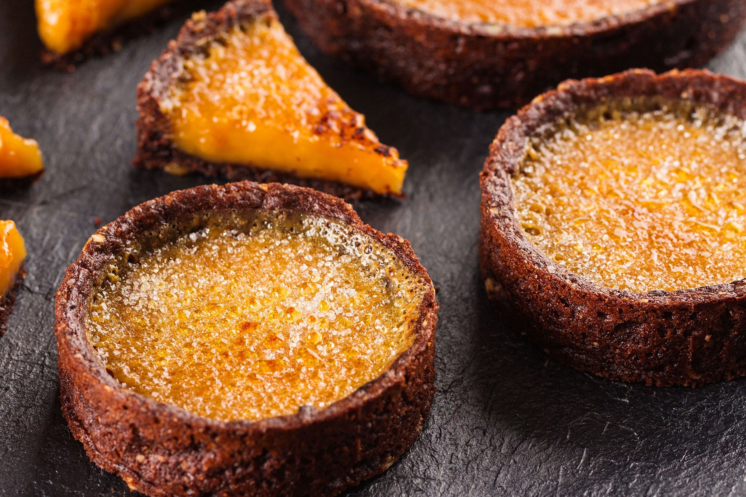 Caramelized pumpkin brulee tarts with crackled sugar tops, representing the Pumpkin Brulee fragrance.
